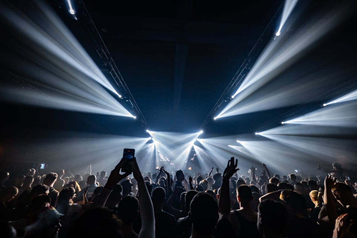 Fans recording and cheering during a live music concert