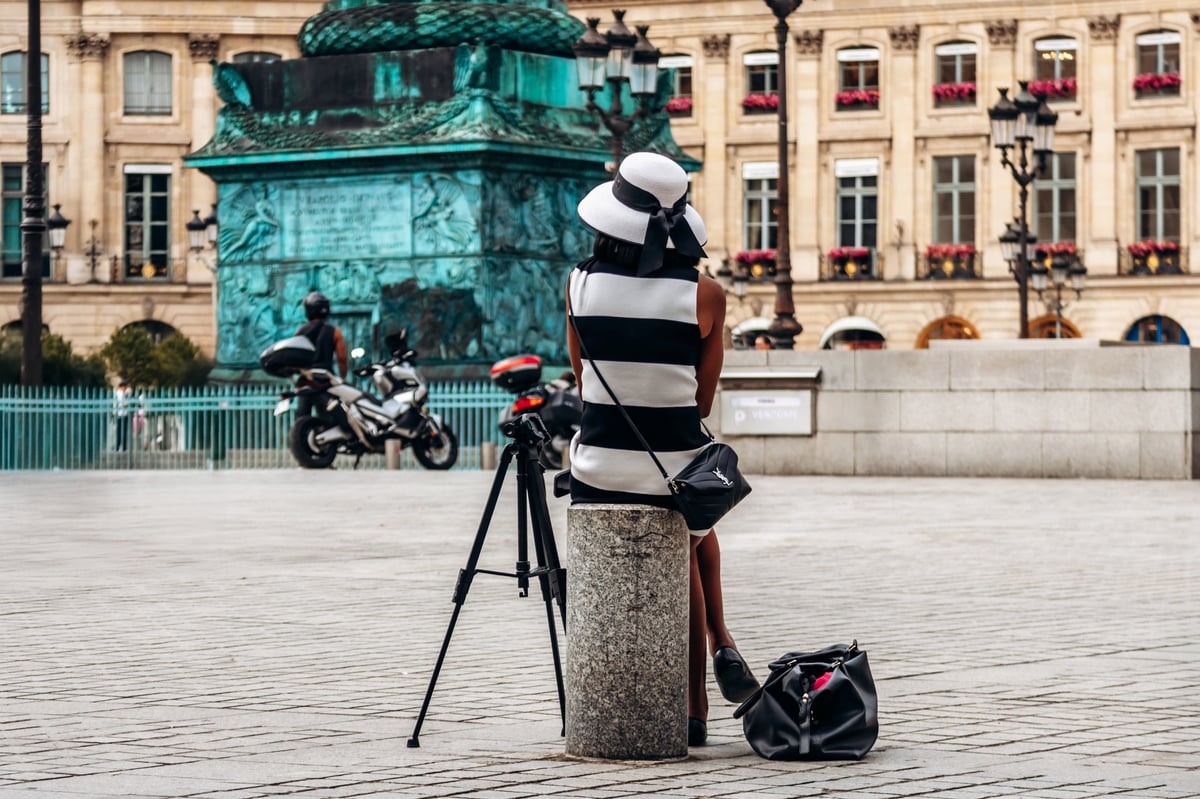 Model resting during a photoshoot on Place Vendôme in Paris