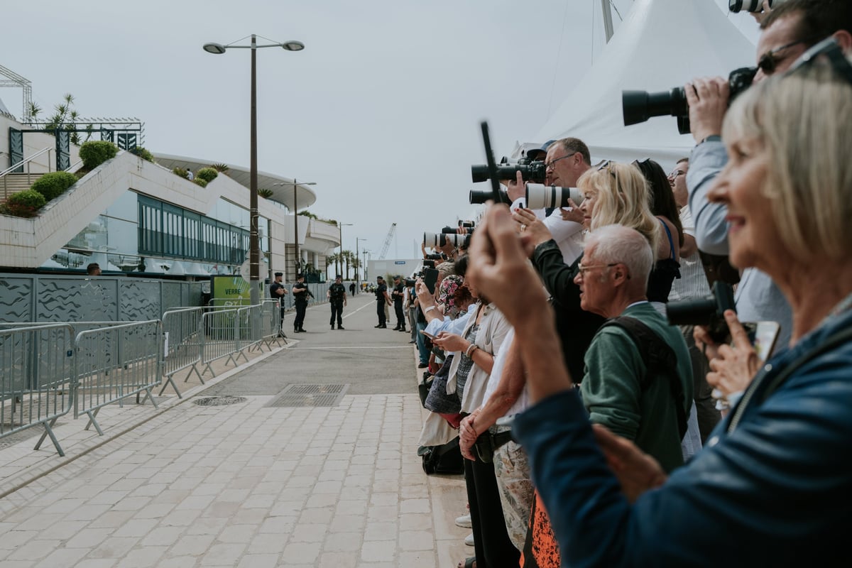 Press photographers capturing arrivals at a photocall during a film festival
