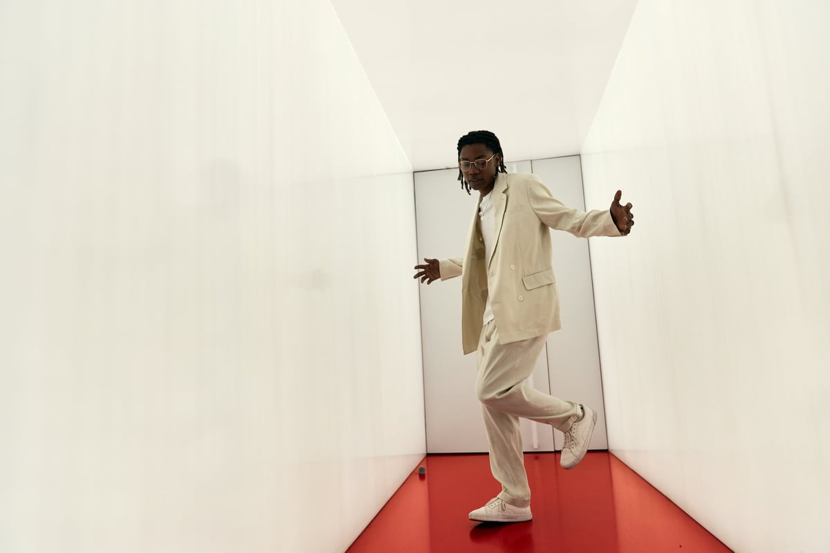 Young man posing and balancing in a narrow corridor