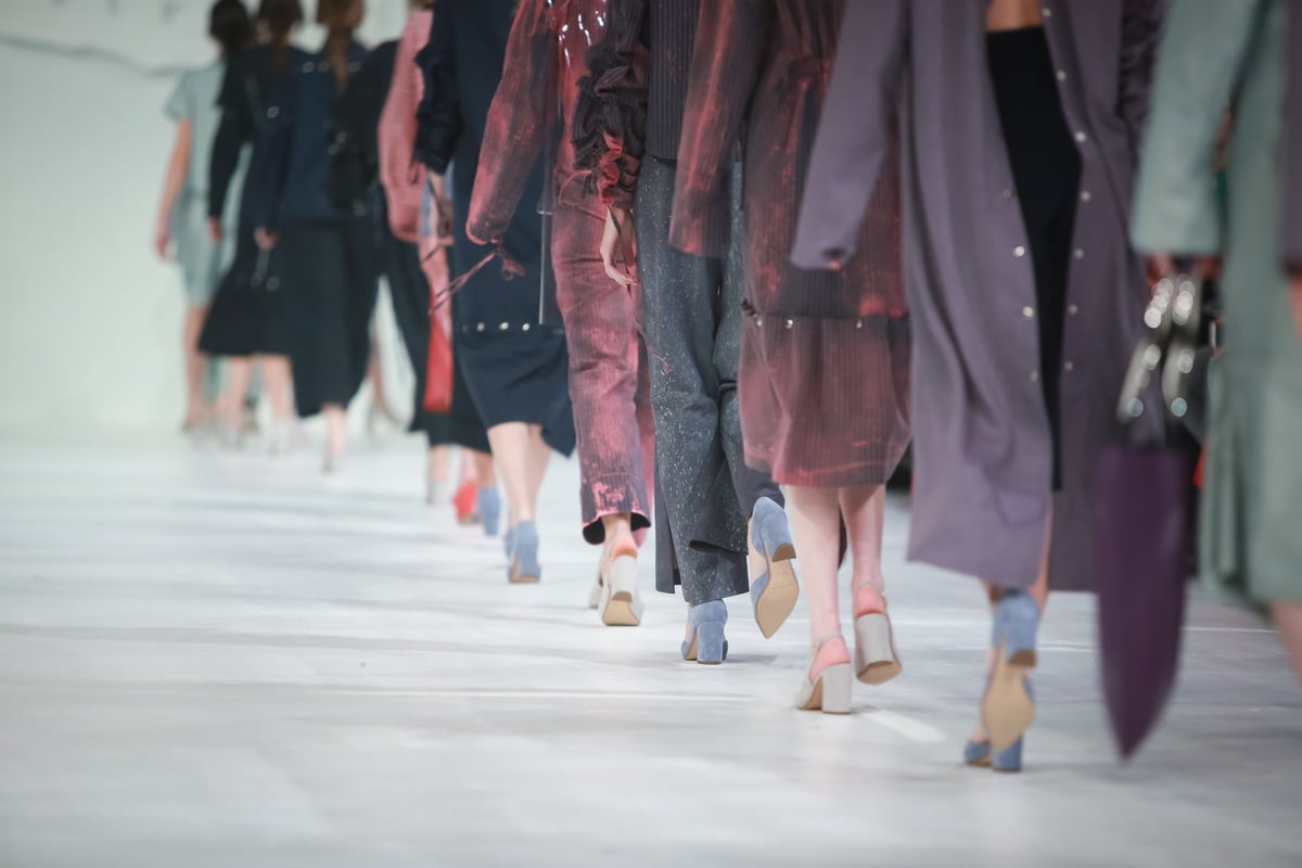 Line-up of models seen from behind on a fashion show catwalk